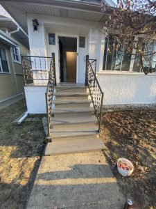 Refinished wooden front stairs with fresh gray paint and clean edges after restoration