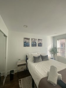 Wooden slat accent wall installation in modern bedroom by Flash Handy