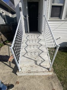 Worn and peeling front porch steps with rusted metal railings – before repair by Flash Handy