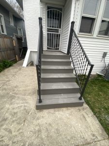 Restored front porch steps with fresh paint and black metal railings – after renovation by Flash Handy