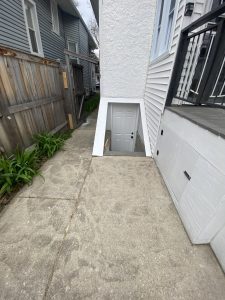Restored basement stairway with fresh concrete framing and sealed finish – Flash Handy